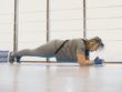 Lady doing a plank exercise in exercise clothes